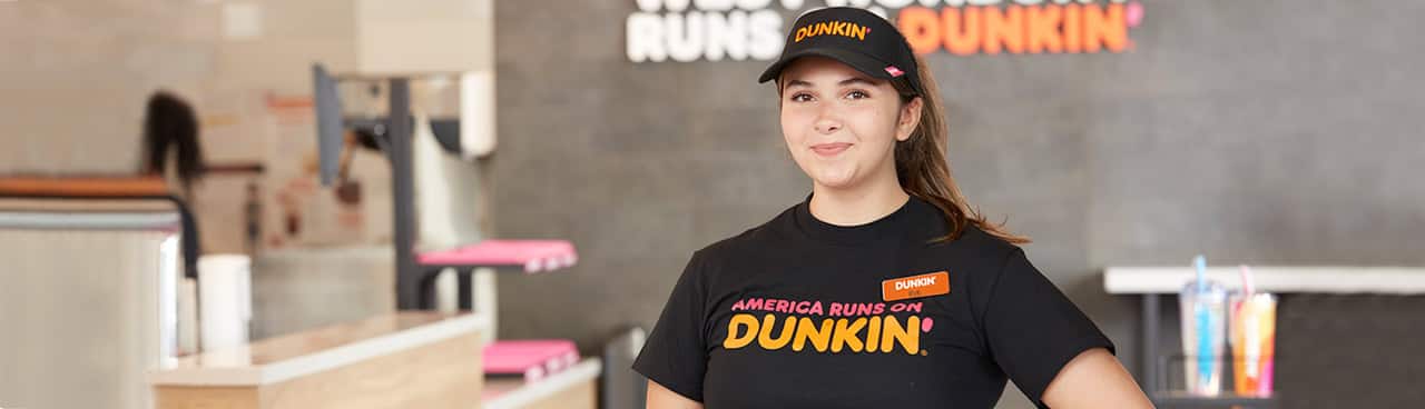 A Dunkin' employee in a Dunkin' store