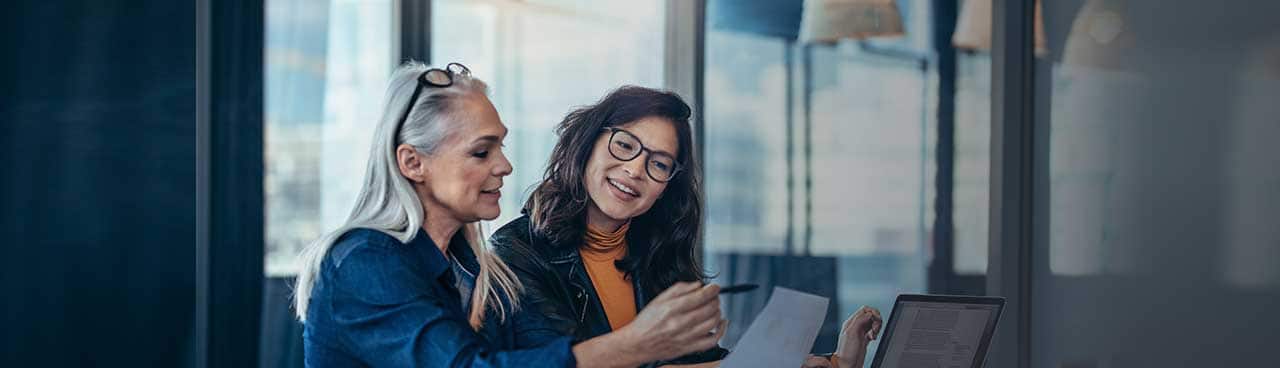 Two co-workers reviewing a report together