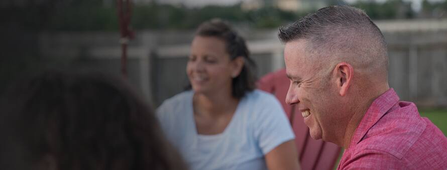 Two individuals sitting outside and laughing