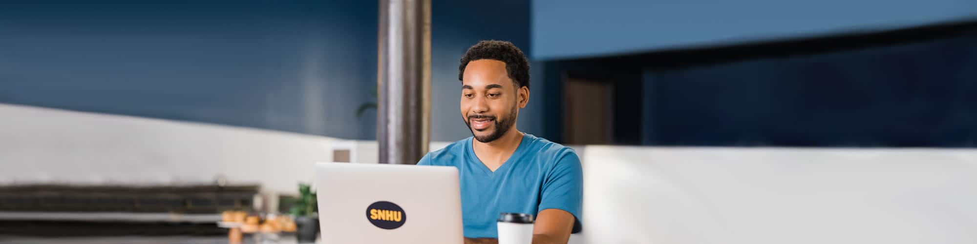 SNHU student working on his laptop