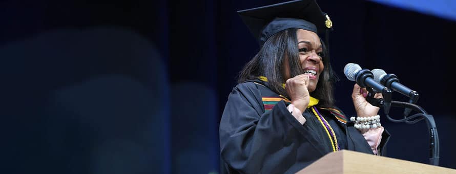 Photo of student speaker Demeeta Hulett at the Online Undergraduate Business and STEM Programs Commencement