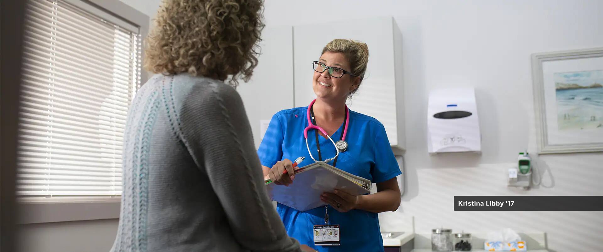 Kristina Libby, who earned her online BSN at SNHU, working in a medical office while wearing scrubs.