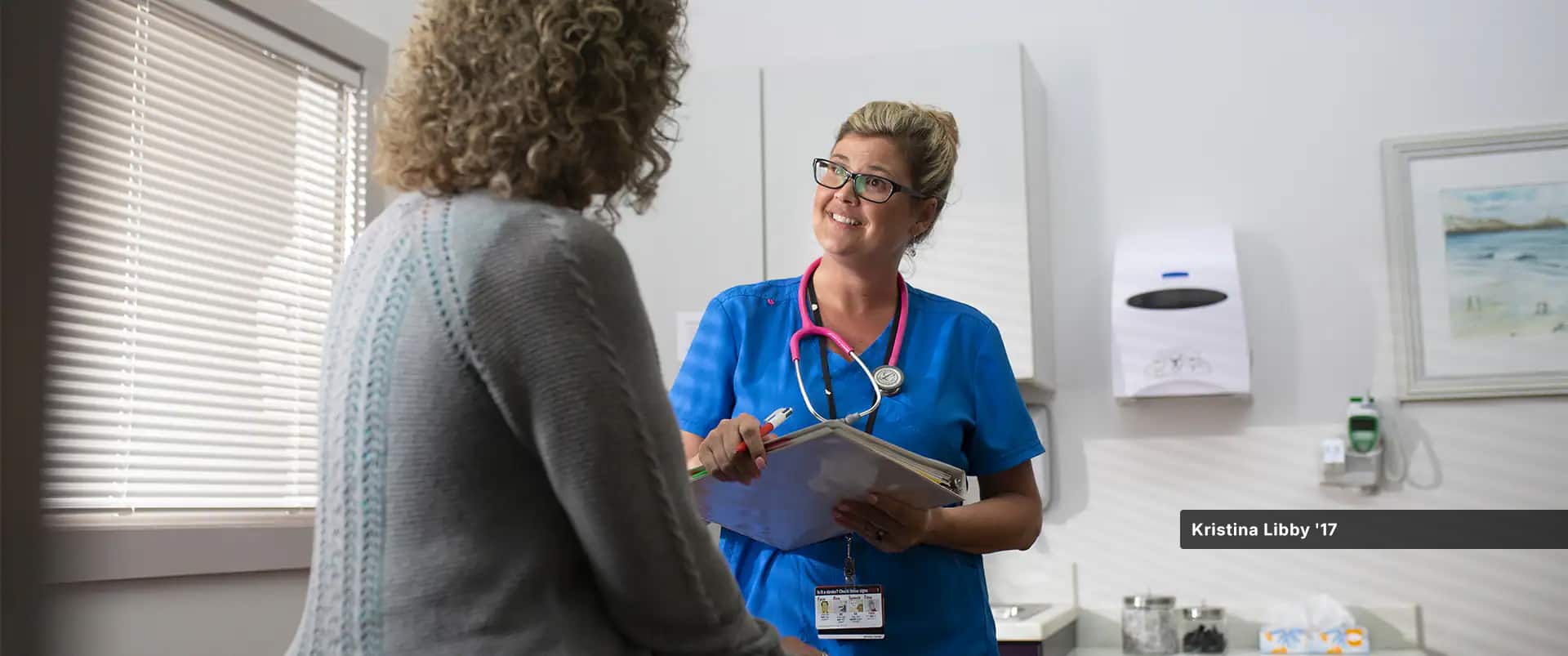 Kristina Libby, who earned her online BSN at SNHU, working in a medical office while wearing scrubs.