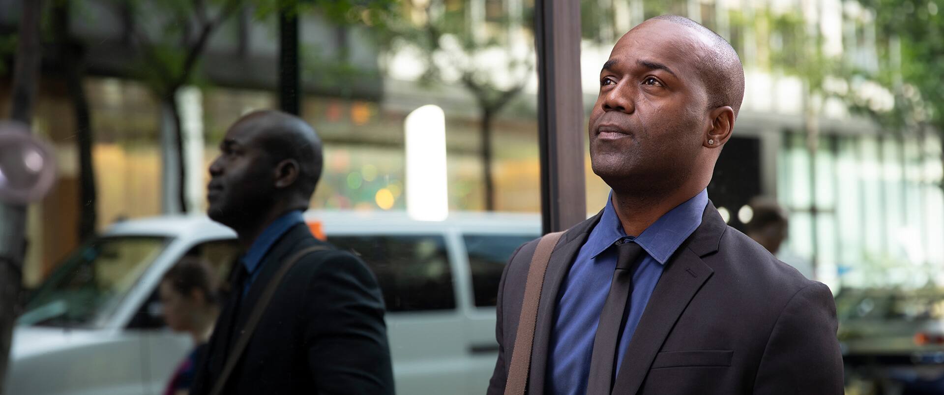 Jean Bisson, an online degree graduate from Southern New Hampshire University, looking inspired in a city setting.