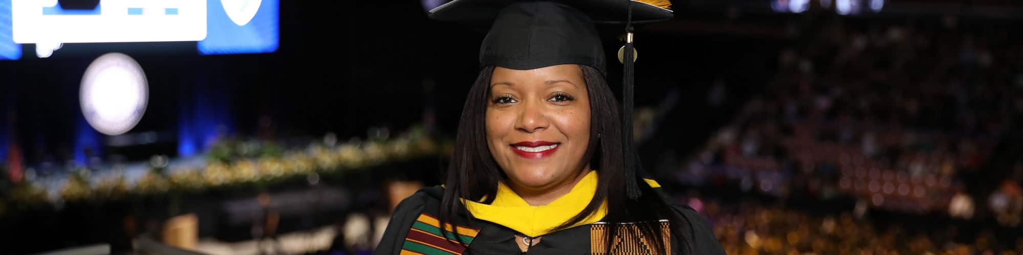 Kimberly Medina wearing her graduation cap and gown at the SNHU commencement ceremony.
