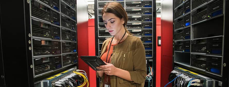 A woman with an associate degree in IT working in a server room