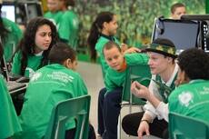 Celtics mascot Lucky interacting with students at Arlington Middle School.