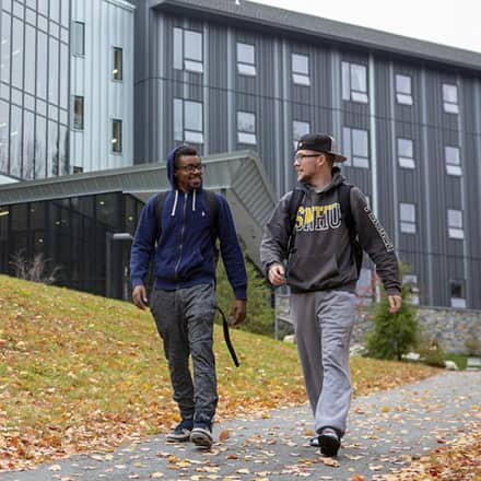 Two students walking in front of Monadnock Hall