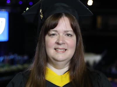 Heather Mair, who earned her bachelor's in accounting in 2023, wearing her cap and gown.