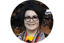 SNHU healthcare administration graduate and California resident Janet Johnson wearing eyeglasses and a graduation cap.
