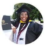 SNHU graduate, Karen Raquel Quezada, standing in her cap and gown with her degree