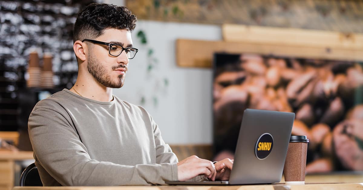 Naeem Jaraysi using a laptop to take online college courses.