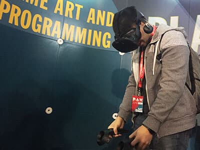 Person playing on the Vive, virtual reality headset.