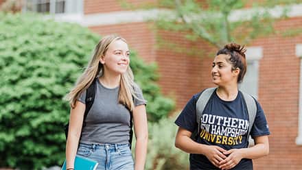 Two students walking on campus