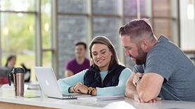 SNHU students talking in a student lounge