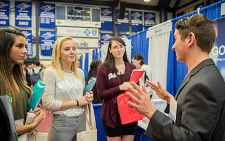 Students talking to a business recruiter