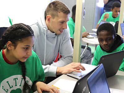 Celtics Forward, Daniel Theis, with student's from the Lego League