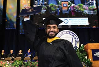 SNHU graduate holding up his diploma at the 2019 Commencement ceremony