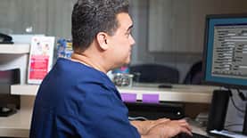 Healthcare professional typing on a computer