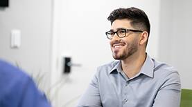Business processional in an office setting while smiling