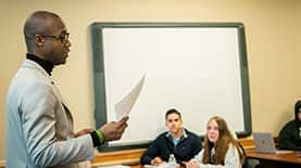 SNHU Professor lecturing in front of students in a classroom