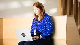 SNHU student typing on a laptop