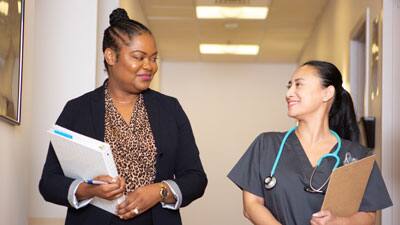 Health Administrator and a Nurse Smiling in Hospital