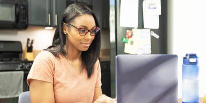 An SNHU student working on a computer