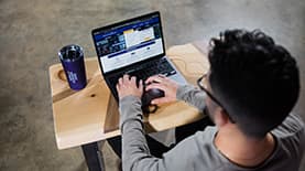 A student browsing the SNHU website on a computer