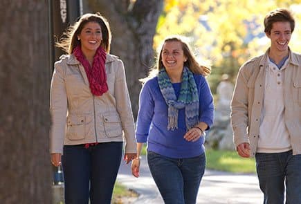 Three potential campus students tour the SNHU campus during an admission event.