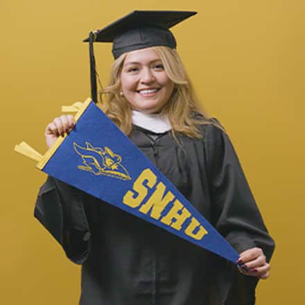 Nelly Bernal, a 2025 graduate who earned her BA in General Studies at SNHU holding a SNHU flag.