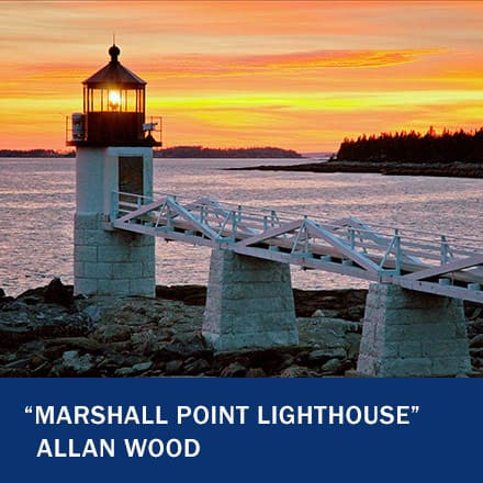 A white lighthouse off a dock with a sunset in the background with the text "Marshall Point Lighthouse" Allan Wood
